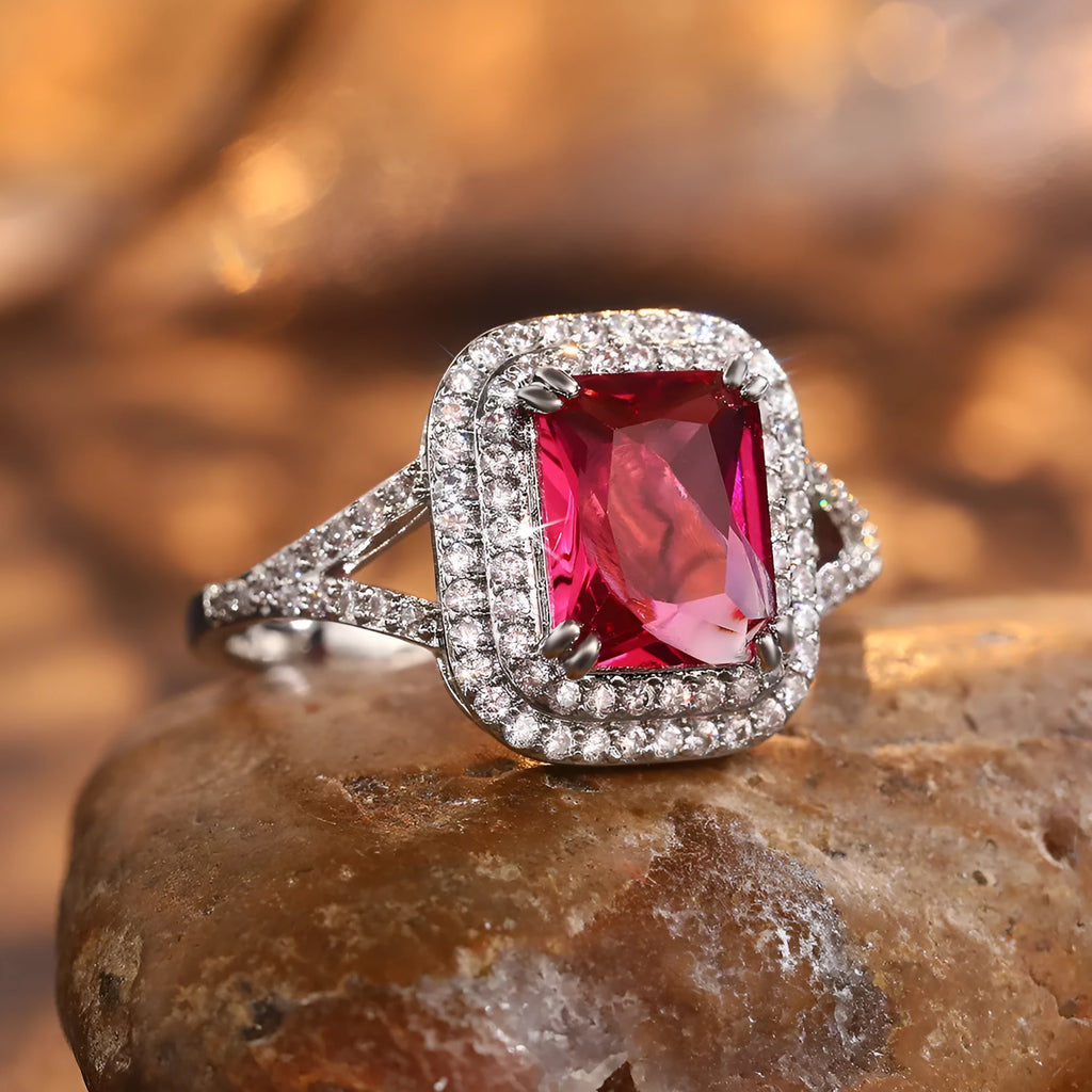 Women's copper ring with a square red rhinestone centrepiece on a geometric band.