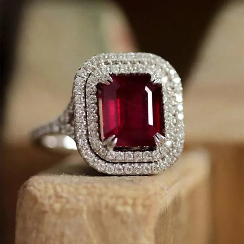 Women's copper ring with a square red rhinestone centrepiece on a geometric band.