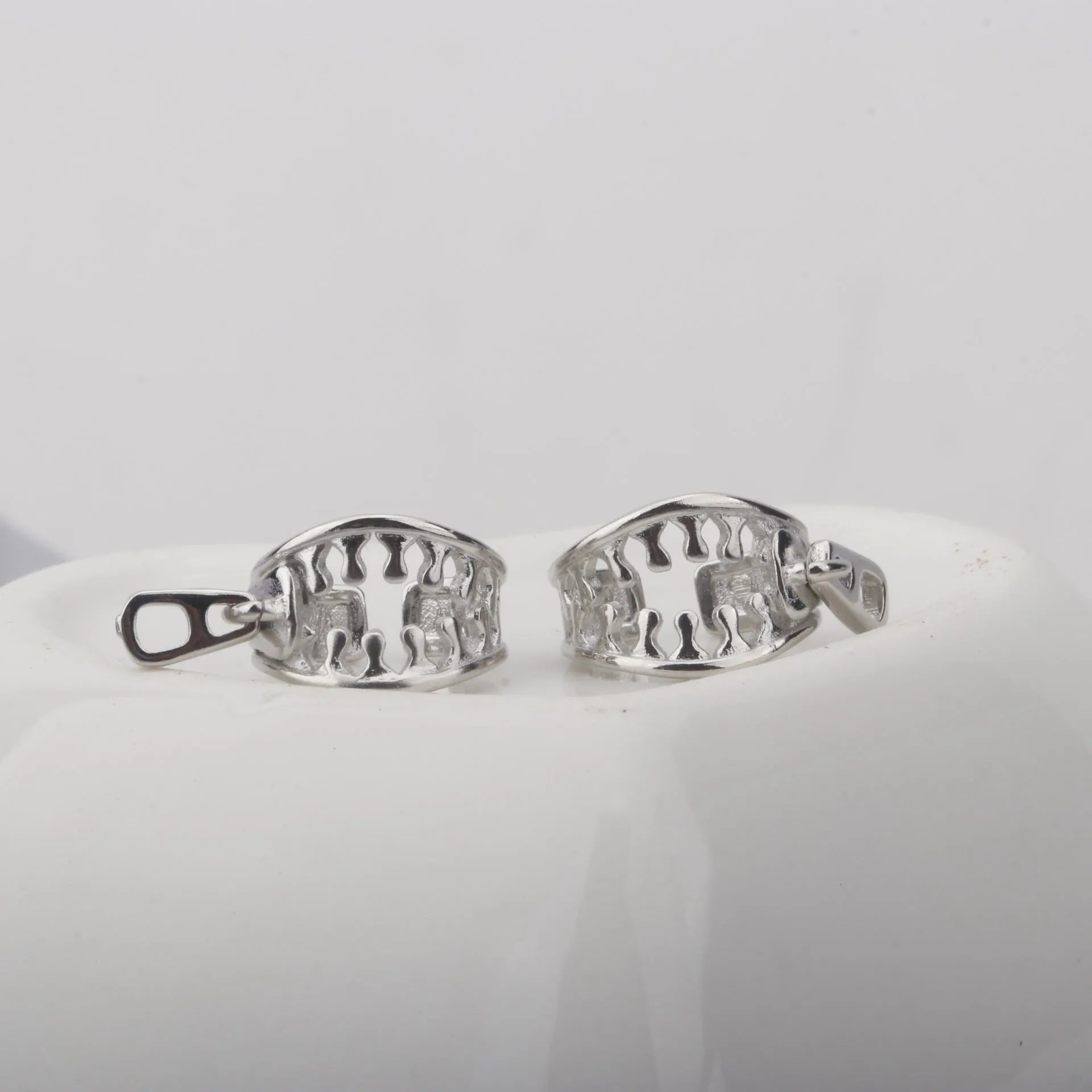 Copper geometric ear clip with line details and a zipper-style clip in colour ES862