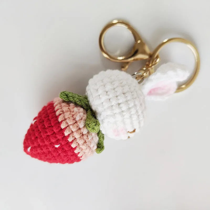 Hand-woven white rabbit strawberry wire pendant charm on a keyring.