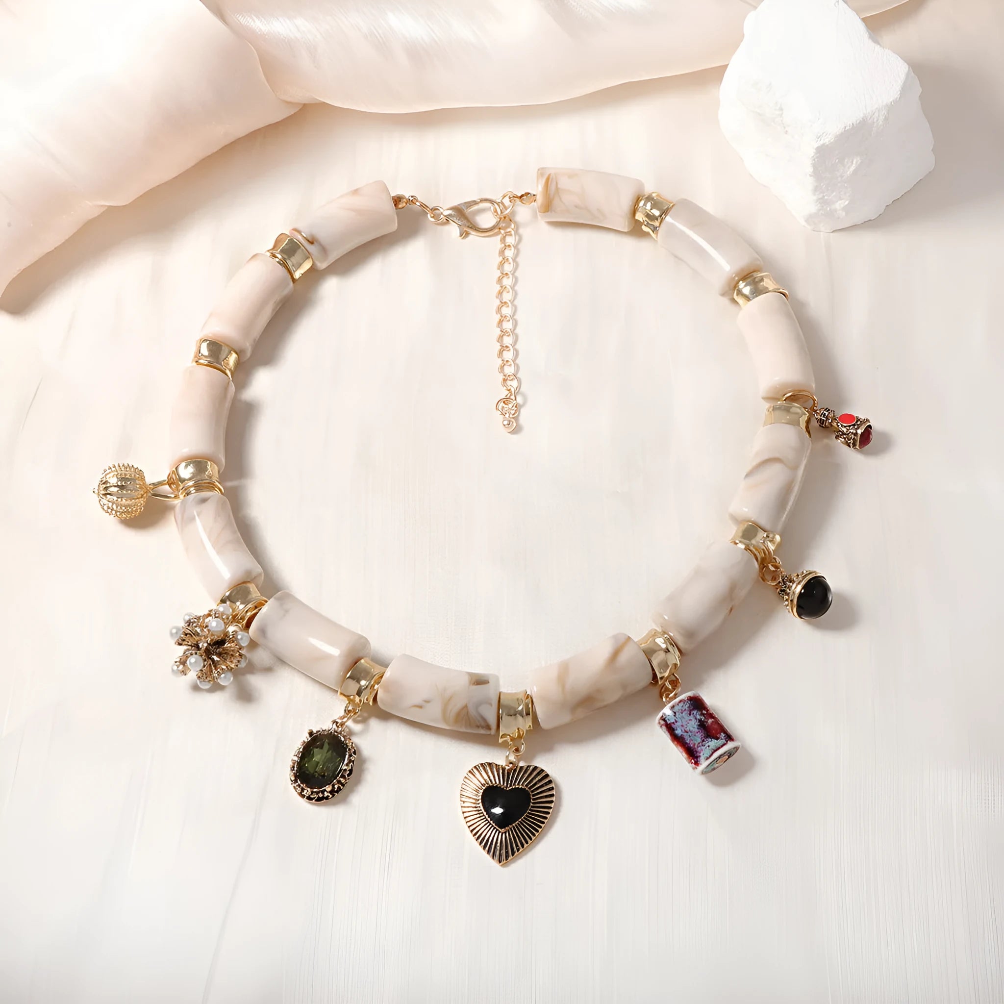 Women's bamboo design heart-shaped resin pendant necklace with electroplated finish.