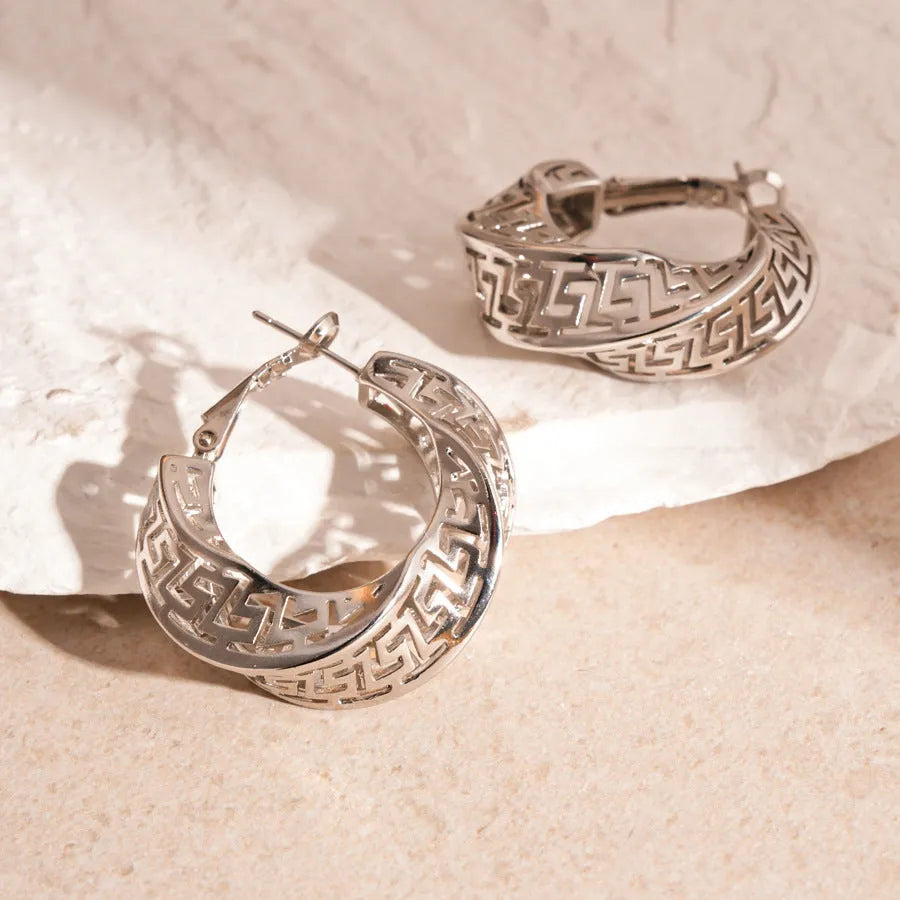 Women's geometric hollow stud earrings with twisted round design in gold and silver options