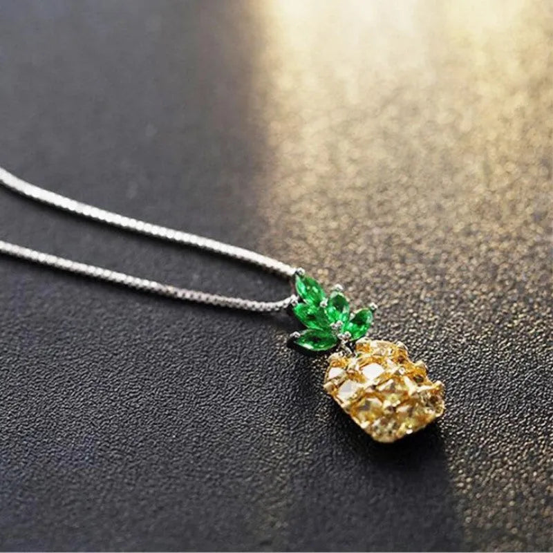 Silver geometric pineapple pendant necklace with a diamond accent on a model