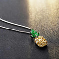 Silver geometric pineapple pendant necklace with a diamond accent on a model
