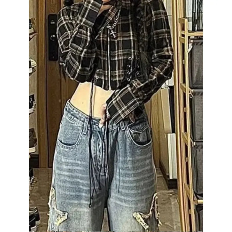 Blue high waist straight leg jeans for women laid flat, showing the denim texture and classic cut.