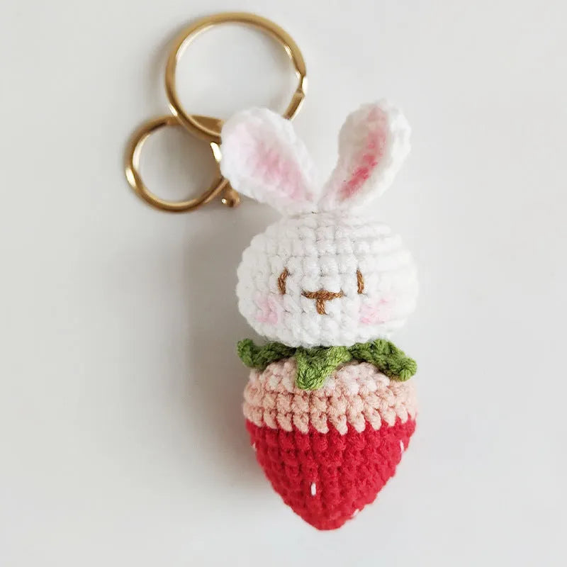 Hand-woven white rabbit strawberry wire pendant charm on a keyring.