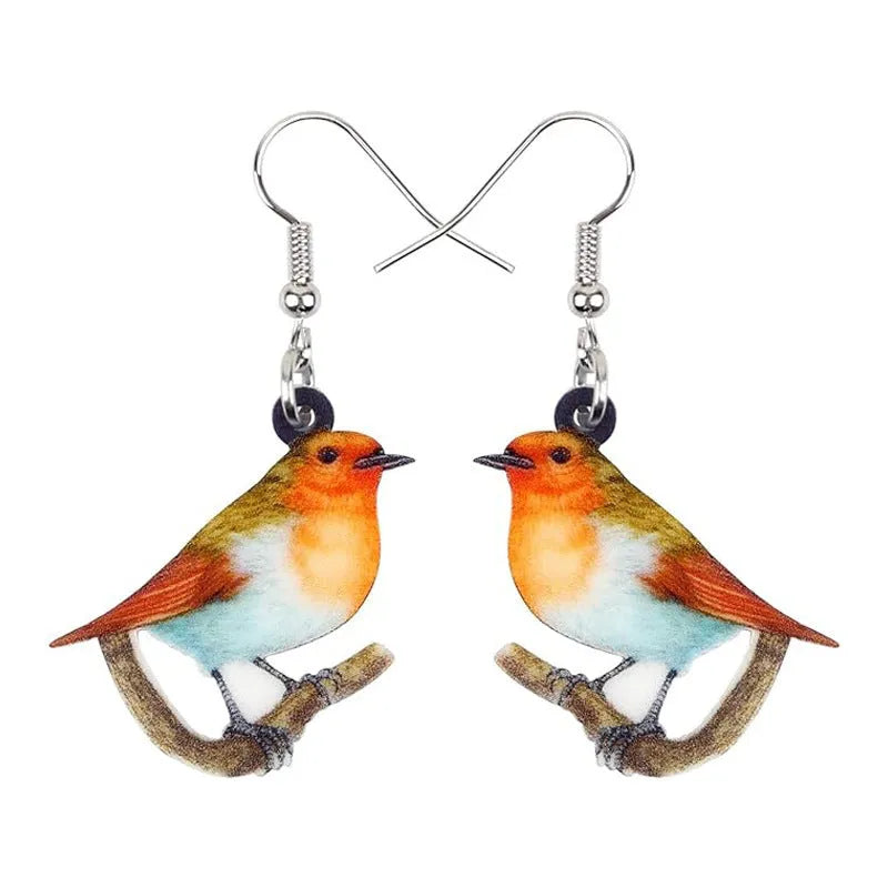 Blue Titmouse bird pendant acrylic earrings with silver snake chain detail on a white background.