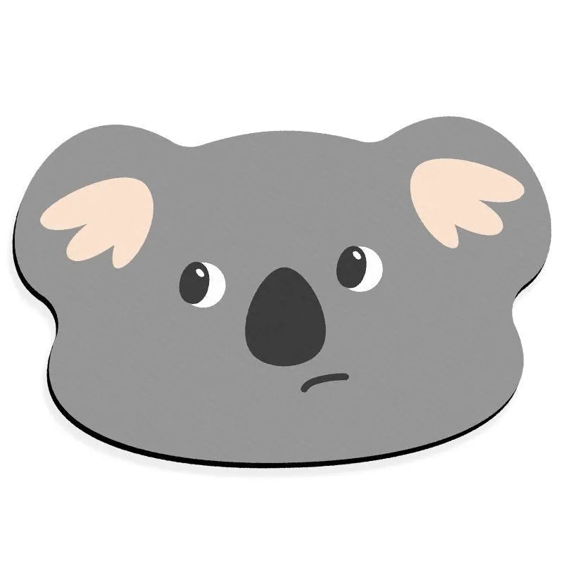 Cartoon animal diatom absorbent bathroom mat in bear pattern on tiled floor.