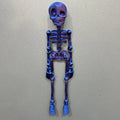 3D printed white skull Halloween fridge magnet on a metal surface showing detailed design.