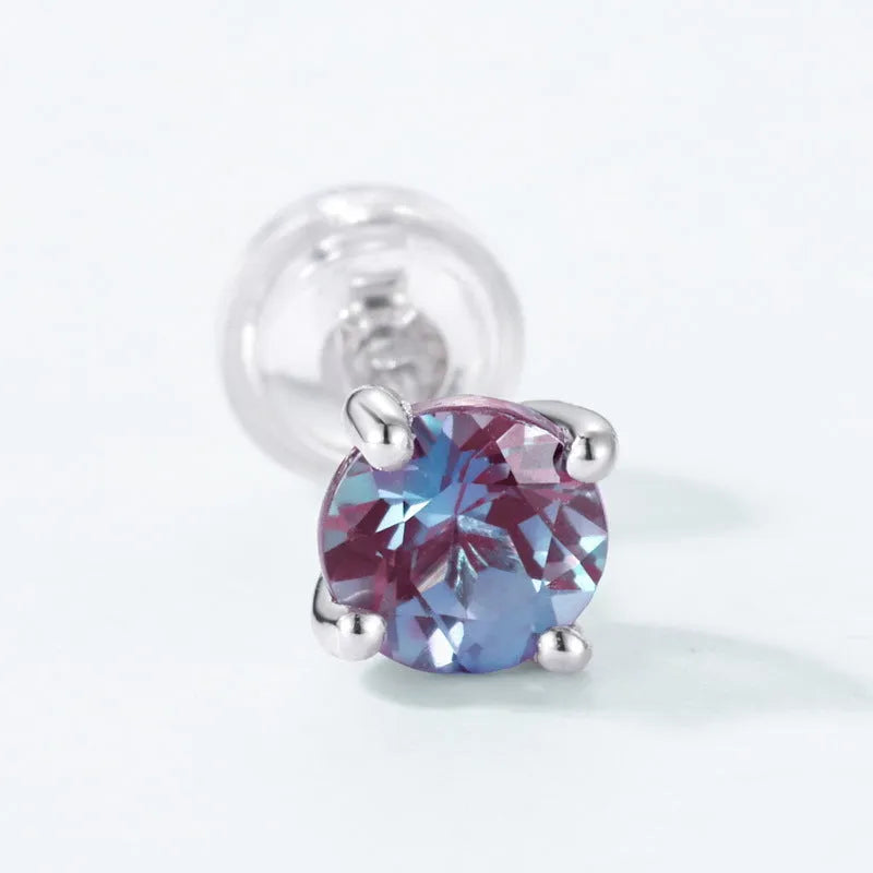 A pair of silver geometric ear studs with a round, coloured Alexander stone setting.