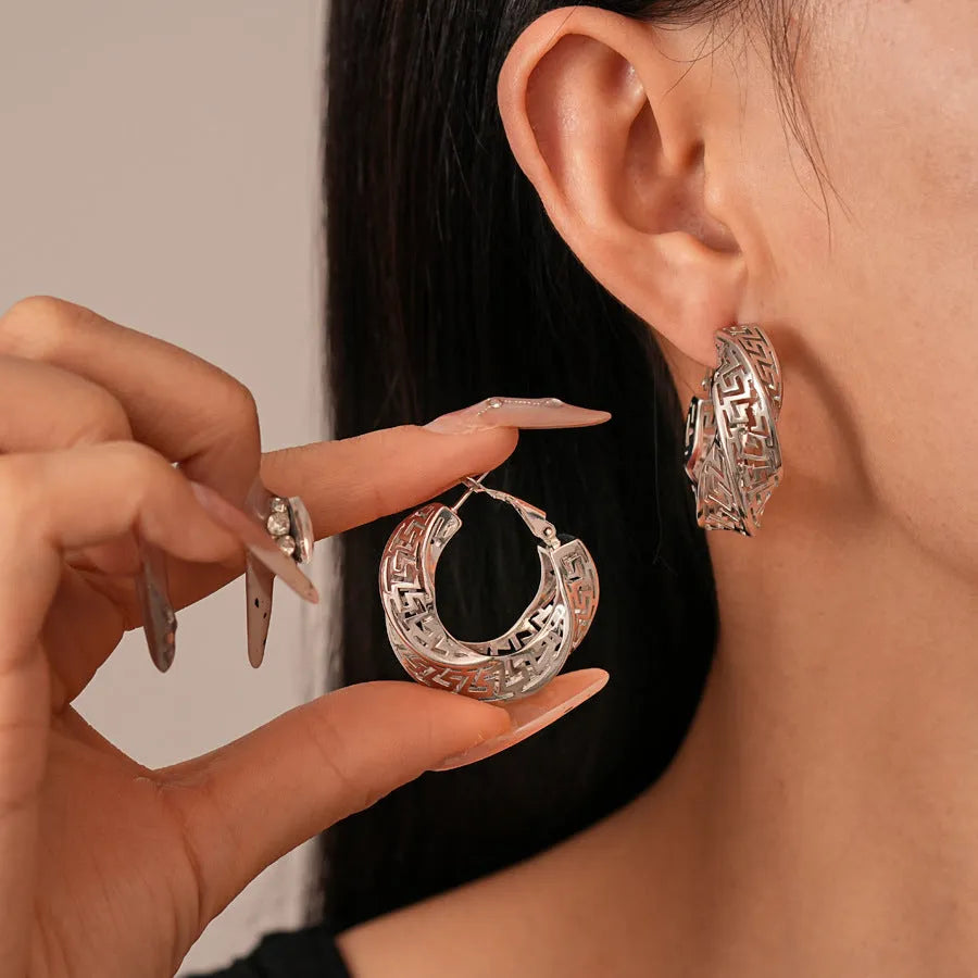 Women's geometric hollow stud earrings with twisted round design in gold and silver options