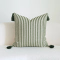 Green striped cotton linen decorative pillow with tassels next to a matching brushed fabric pillow core.