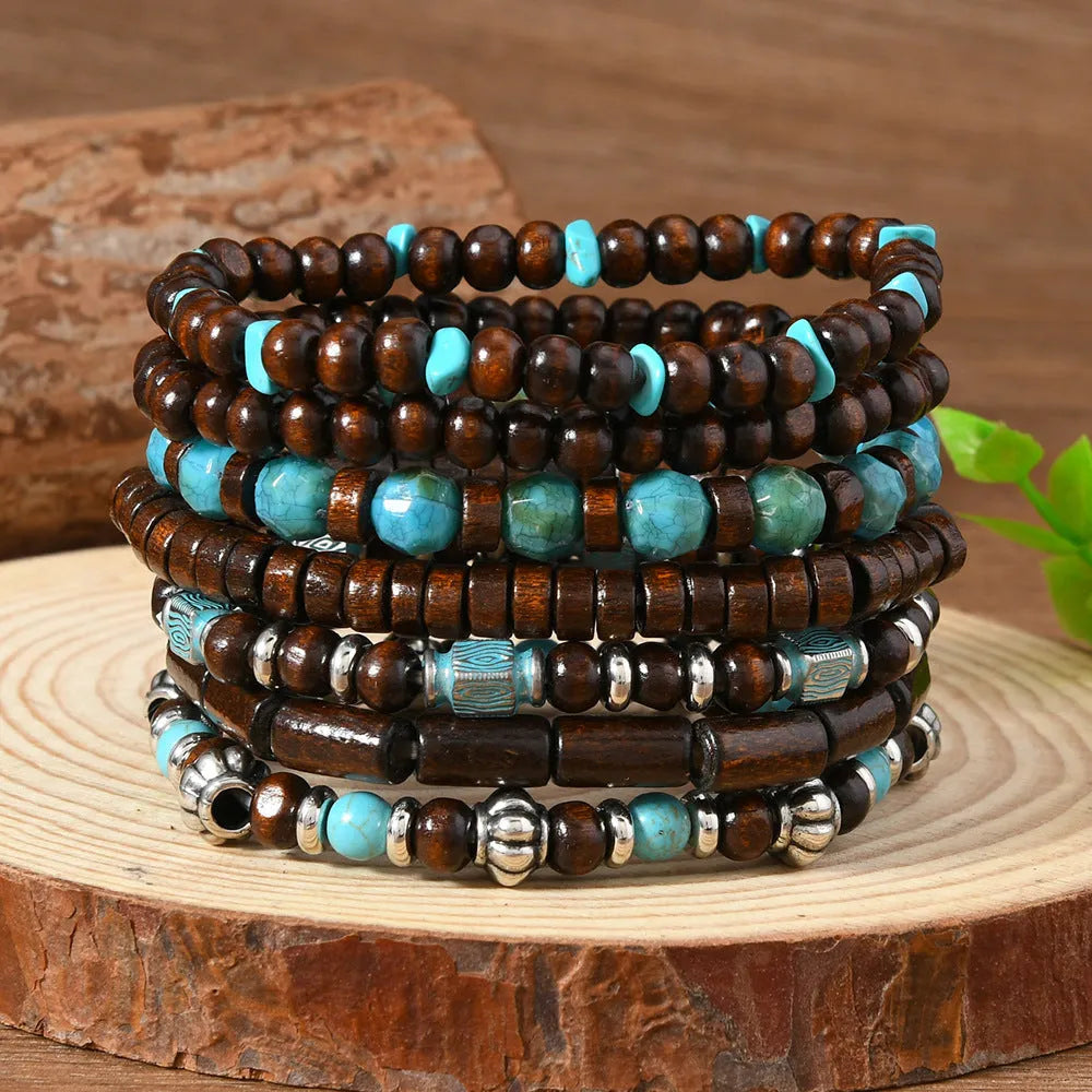 Set of seven layered retro bracelets with wooden beads, alloy metal, and multicolour stones.