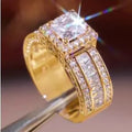 A geometric silver-tone women's ring with a round design element on a model's hand.