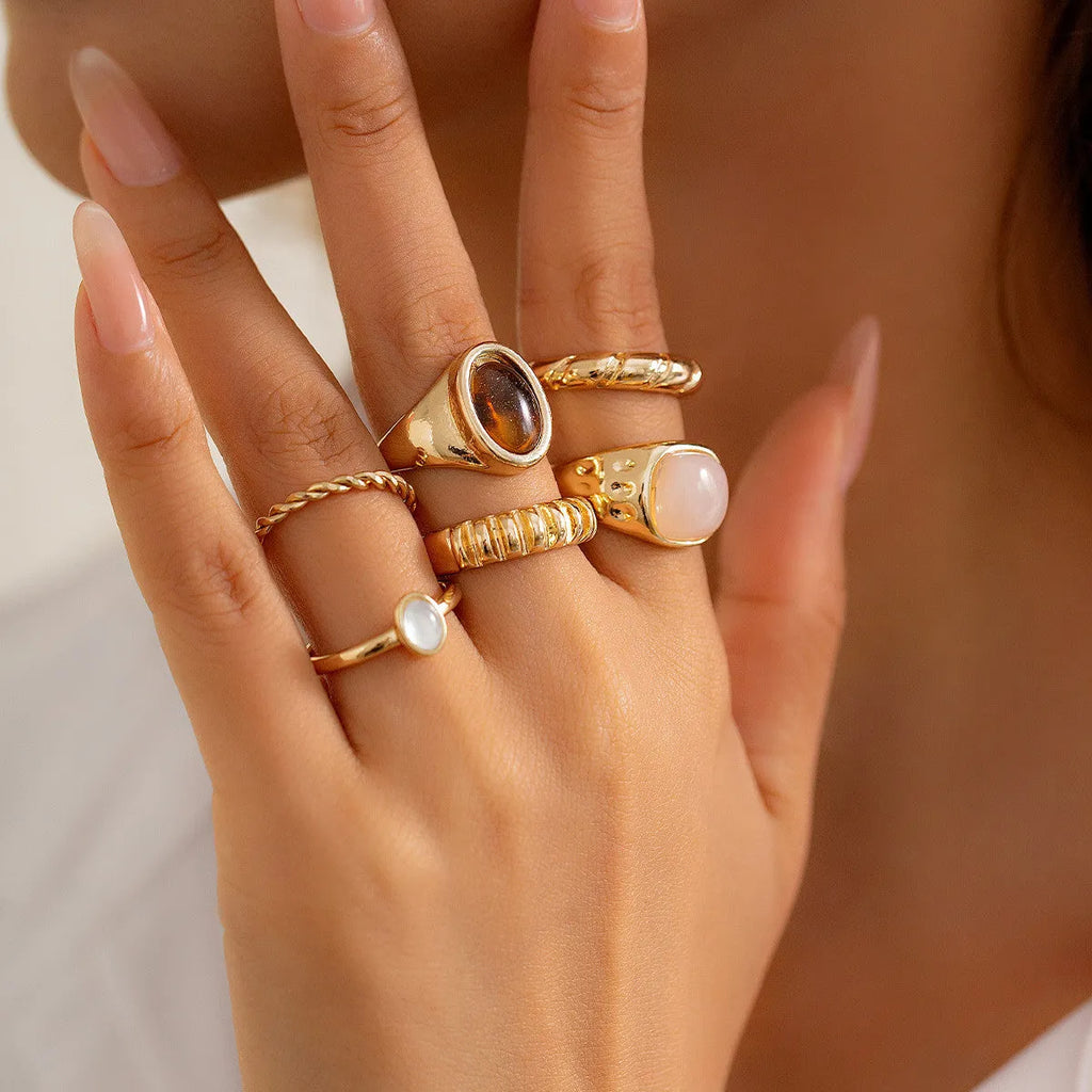 Six light gold electroplated alloy rings in a geometric set with round and ring shapes, style 94509
