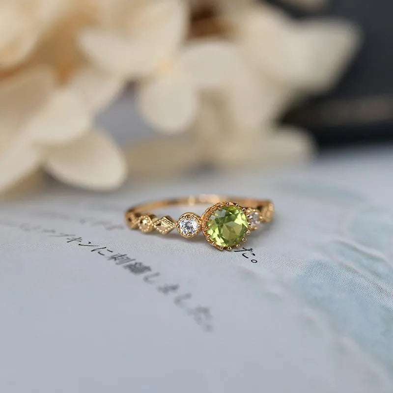 Copper ring with a green quadrilateral imitation peridot stone in a geometric Japanese retro style.