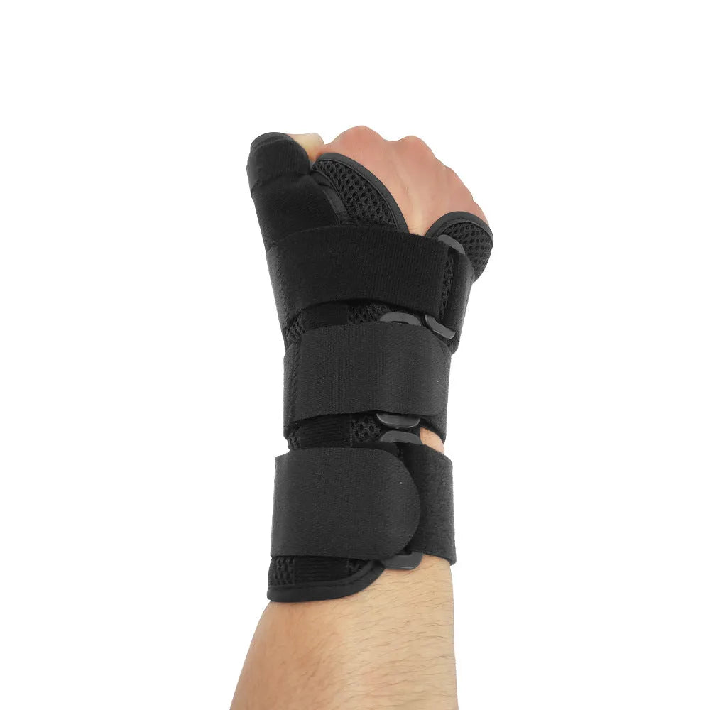 Carbon fibre sports wrist guard with thumb strap in black and grey, shown for left hand.
