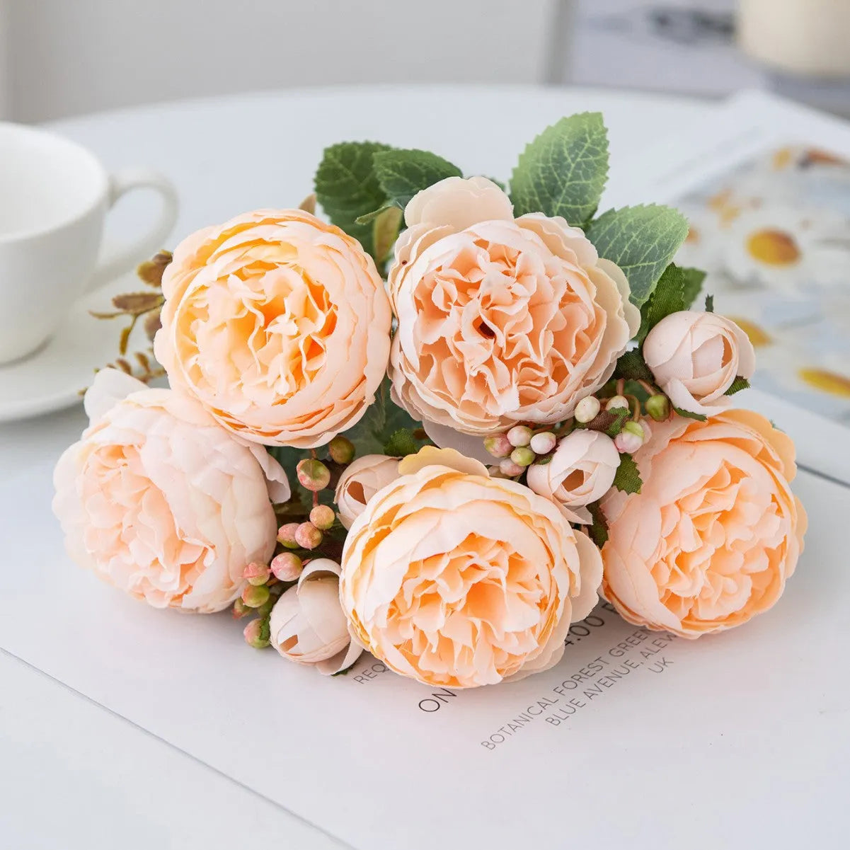 Artificial silk peony bouquet in a vase, showing realistic pink and champagne coloured blooms for home decor.
