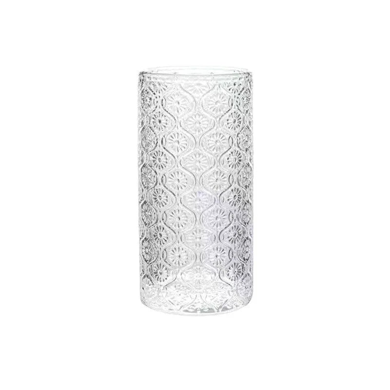 Clear glass water cup with carved Begonia flower pattern, shown in short and tall sizes.