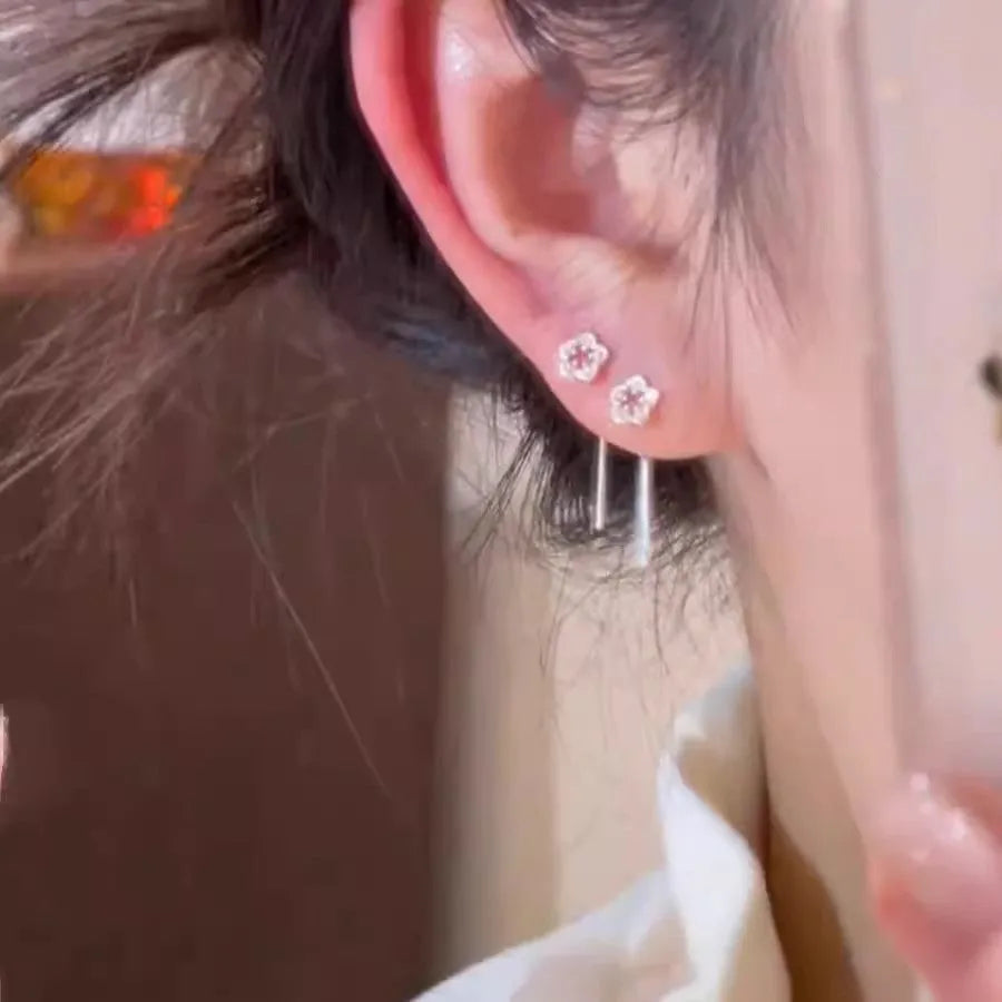 Silver-coloured alloy hollow flower hanging earrings with petal details on sterling silver needles