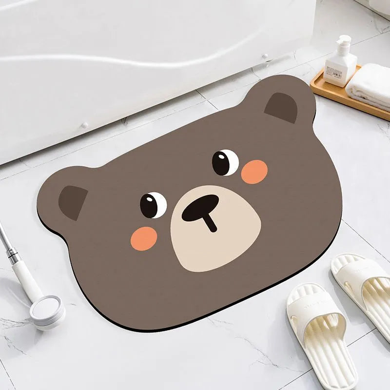 Cartoon animal diatom absorbent bathroom mat in bear pattern on tiled floor.