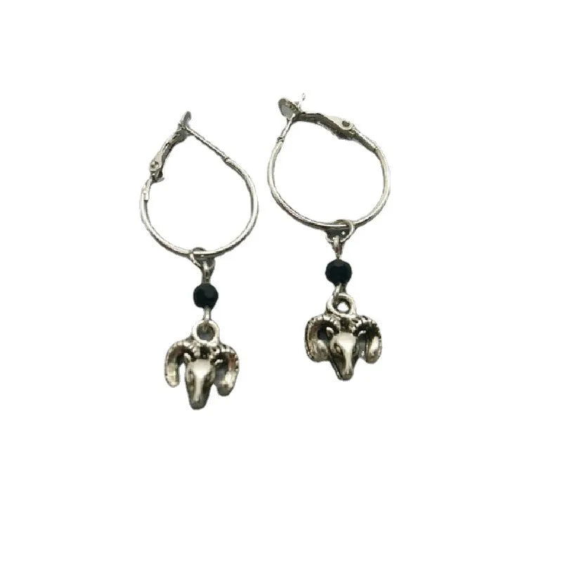 A pair of silver-coloured round ring earrings featuring a detailed Tibetan antelope design.
