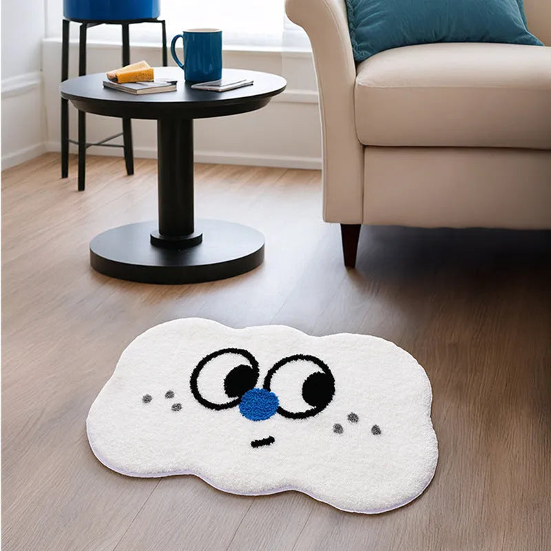 Big eye clouds cartoon patterned bathroom mat in soft green on a bathroom floor.