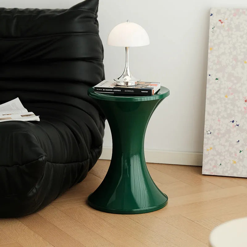 A plastic hourglass-style shoe changing stool, shown in one of the available colours.