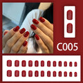 Short solid colour false nails in New Year red with marble pattern, 24 pieces per box with glue for ladies.