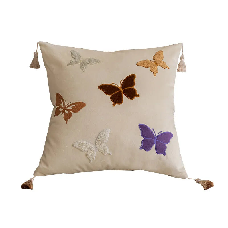 Square decorative cushion with Chinese-style butterfly embroidery in beige, black, and purple colours.