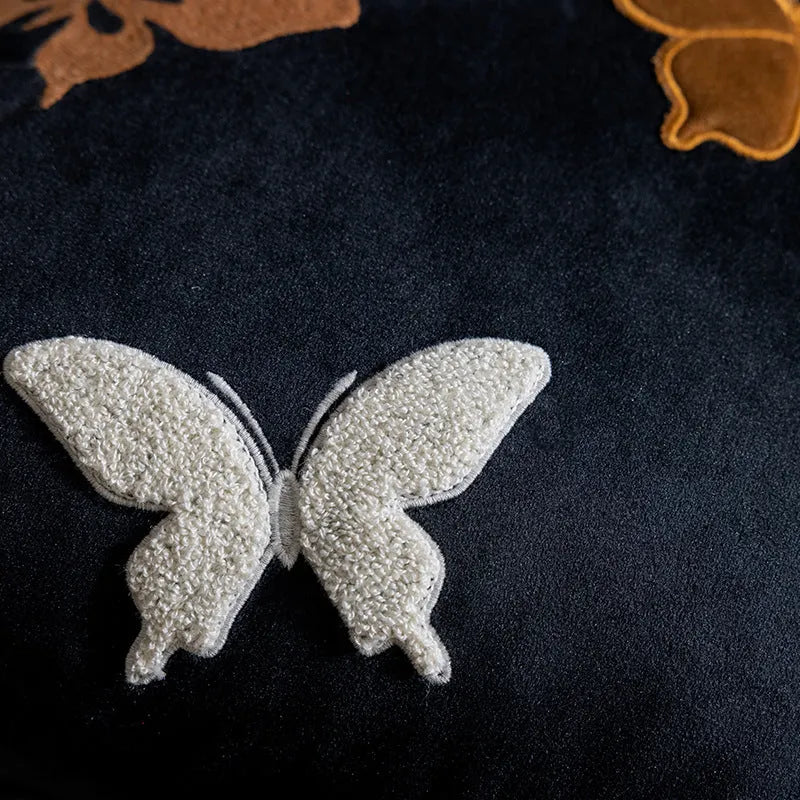 Square decorative cushion with Chinese-style butterfly embroidery in beige, black, and purple colours.