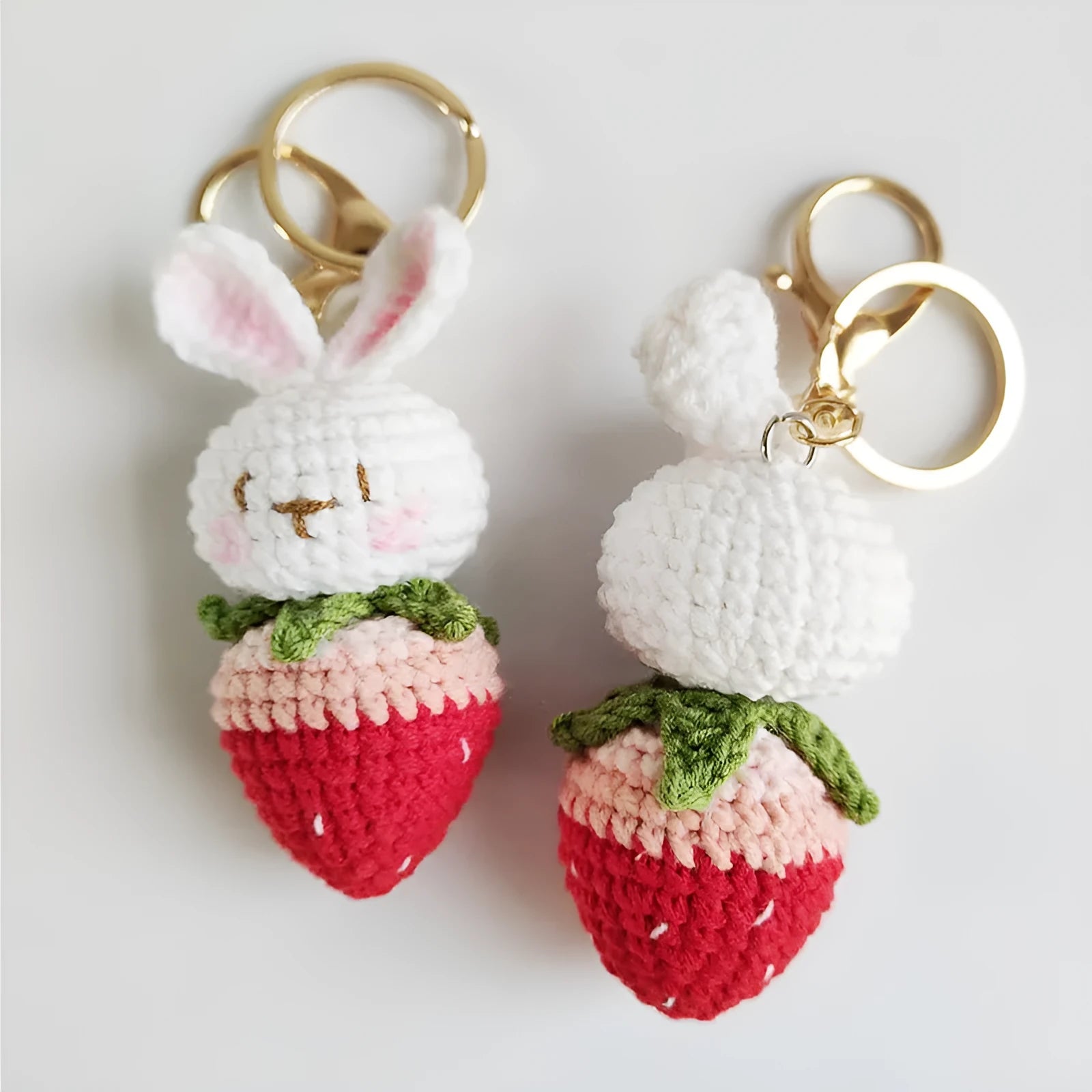 Hand-woven white rabbit strawberry wire pendant charm on a keyring.