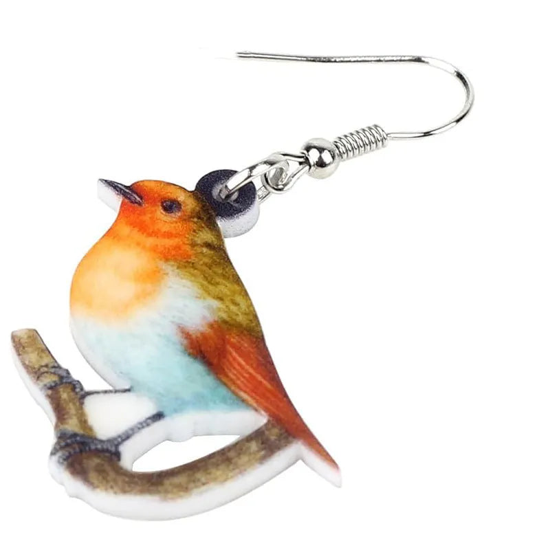 Blue Titmouse bird pendant acrylic earrings with silver snake chain detail on a white background.