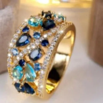 Women's round hollow copper fashion ring with a choice of diamond or sapphire blue gemstone accent.