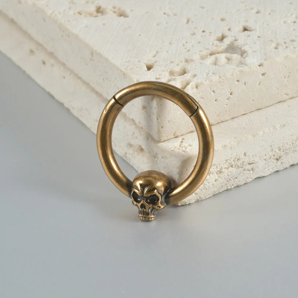 Copper antique finish punk earring with ghost head design in silver or gold.