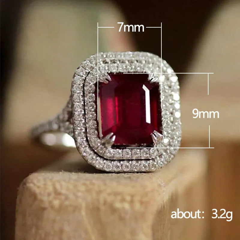 Women's copper ring with a square red rhinestone centrepiece on a geometric band.