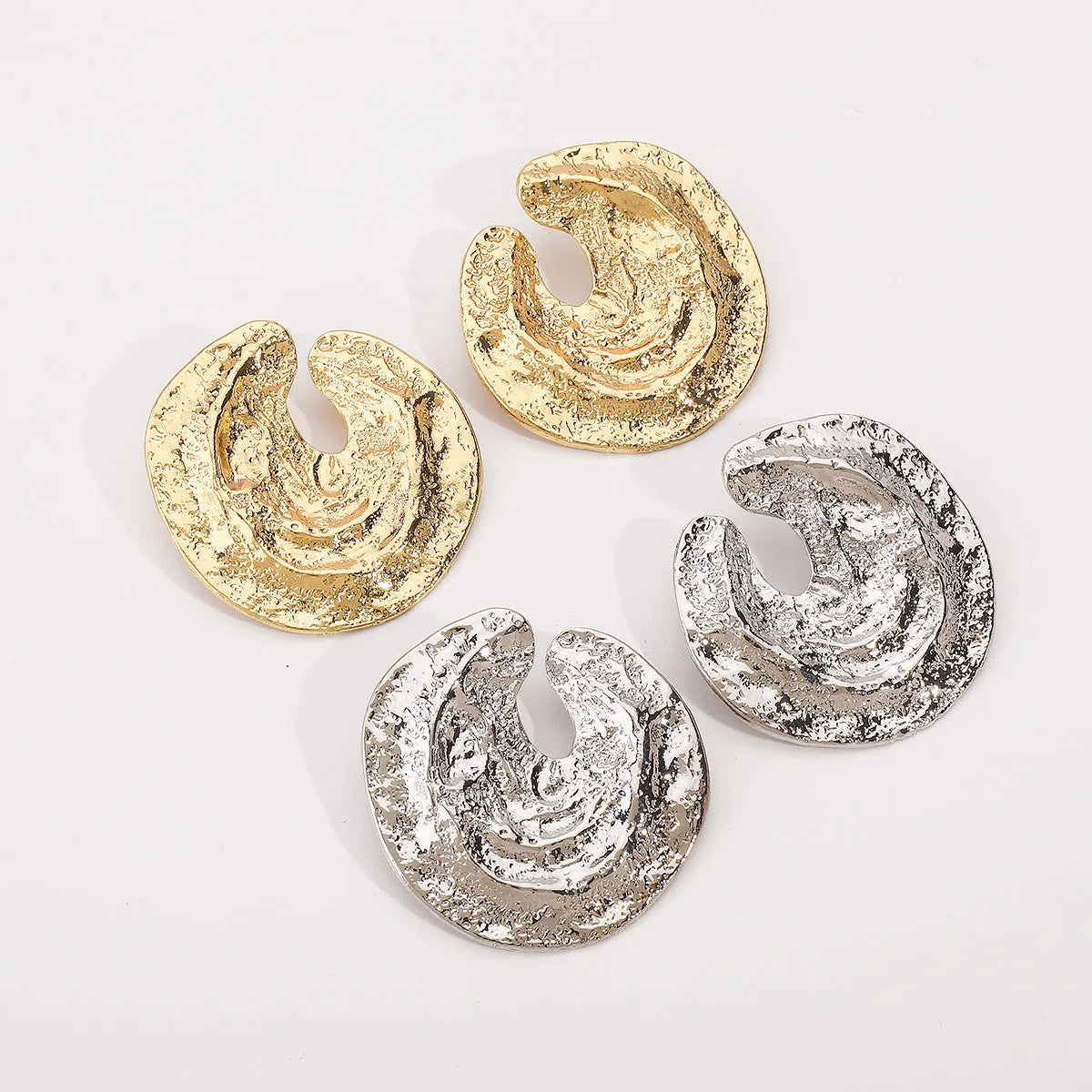 Exaggerated geometric women's earrings with irregular pleating and cold concave-convex texture in gold colour