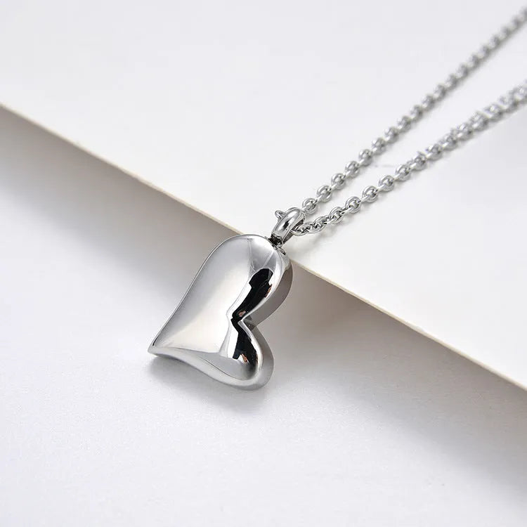 Curved peach heart silver necklace with stainless steel chain and adjustable extension