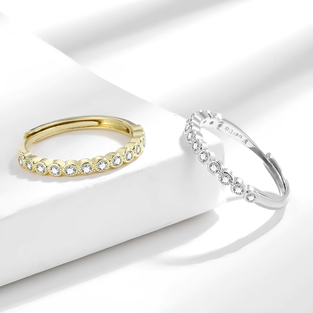 Women's geometric open mouth ring in electroplated gold colour on a plain background.