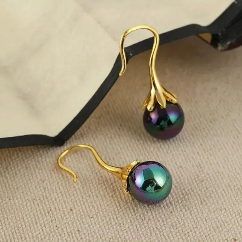 A pair of retro-style women's fashion earrings with an imitation gold electroplated finish.