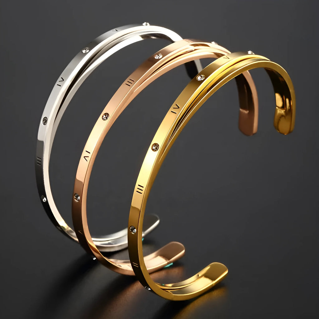 Open-ended stainless steel bracelet with inlaid zircon stones in a love-themed design, shown in rose gold colour.