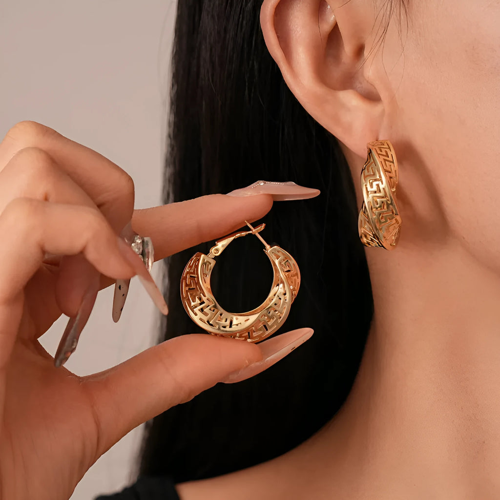 Women's geometric hollow stud earrings with twisted round design in gold and silver options
