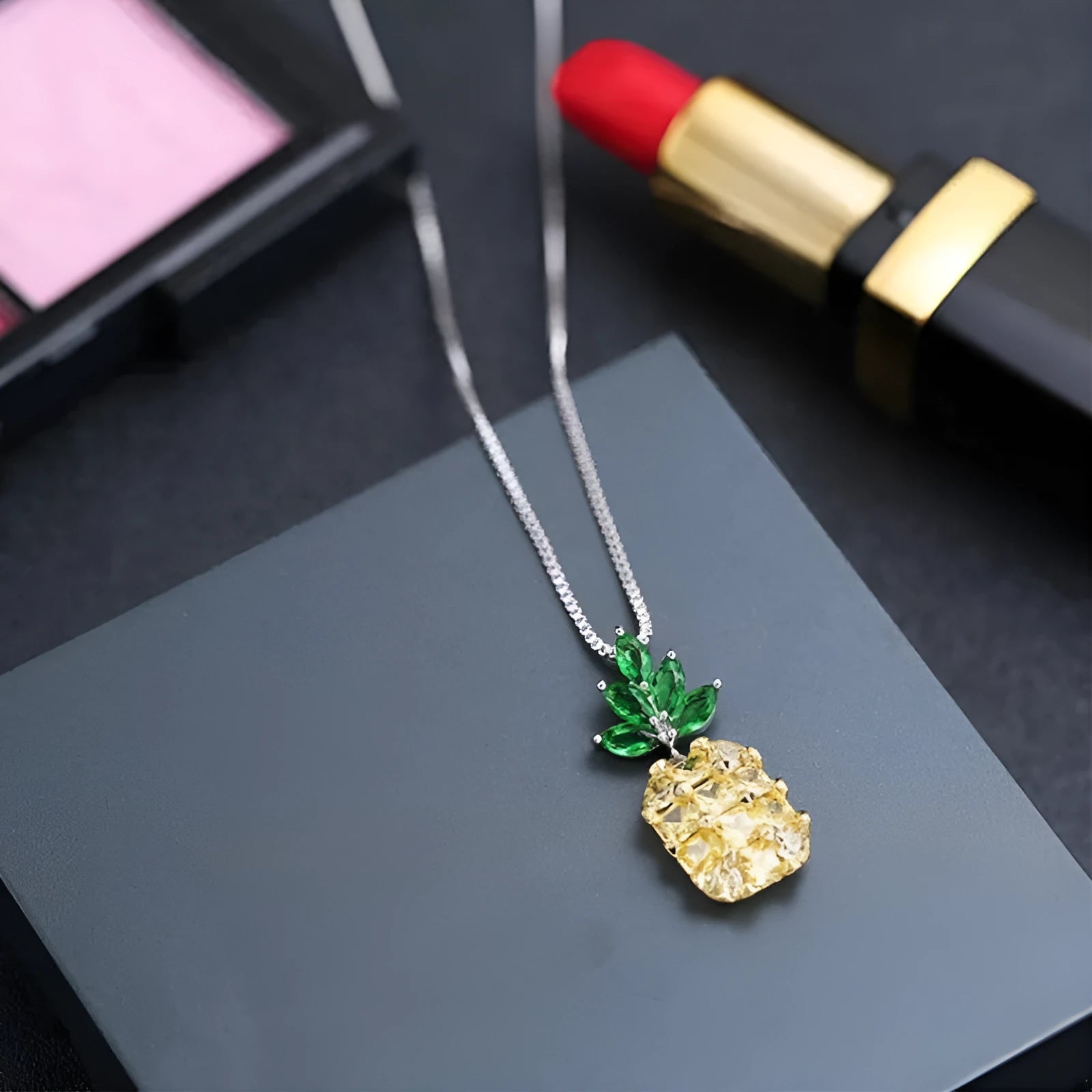 Silver geometric pineapple pendant necklace with a diamond accent on a model