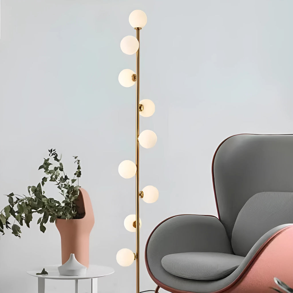 A tall, minimalist Nordic-style floor lamp with a wrought iron frame, glass details, and a circular marble base.
