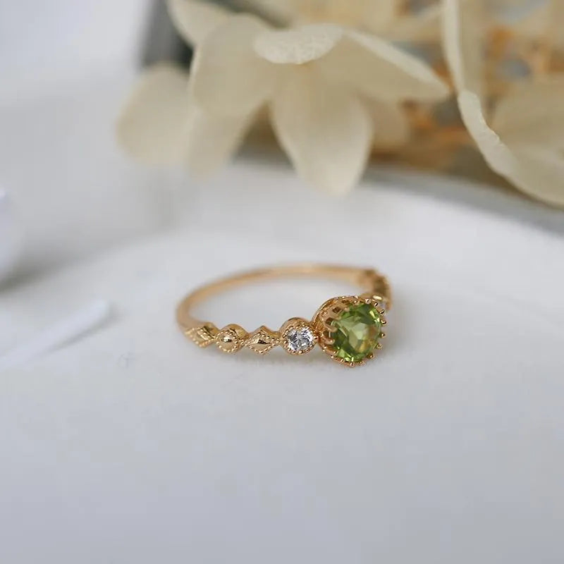 Copper ring with a green quadrilateral imitation peridot stone in a geometric Japanese retro style.