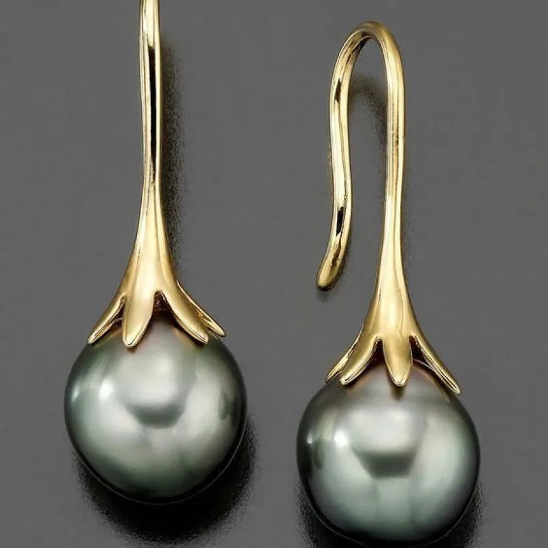 A pair of retro-style women's fashion earrings with an imitation gold electroplated finish.