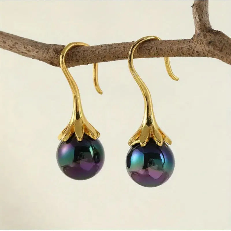 A pair of retro-style women's fashion earrings with an imitation gold electroplated finish.
