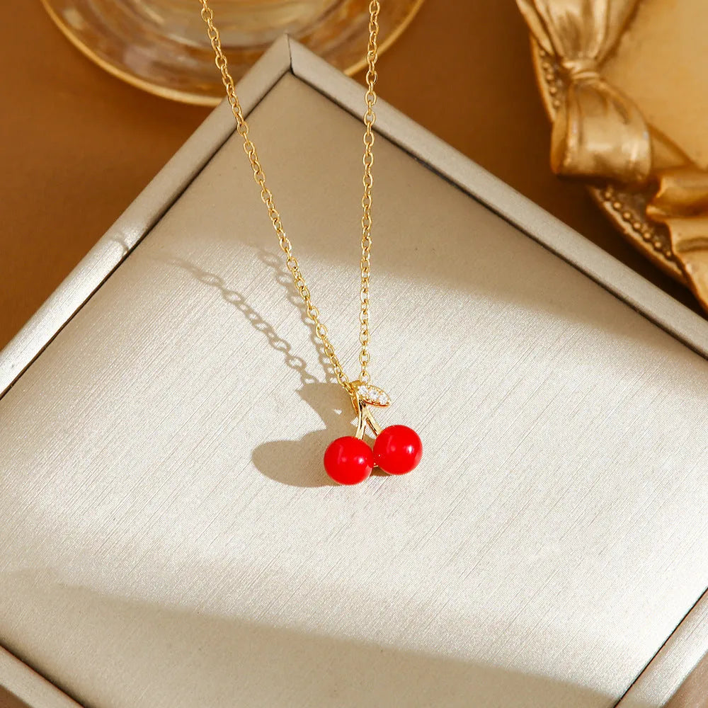 Red delicate indie necklace with cherry, strawberry, and pepper charms on a titanium steel O-ring chain.