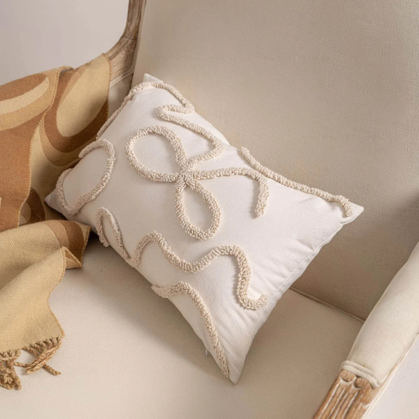 Knitted decorative cushion cover with tassel fringe in spiral dots pattern showing 45x45cm size