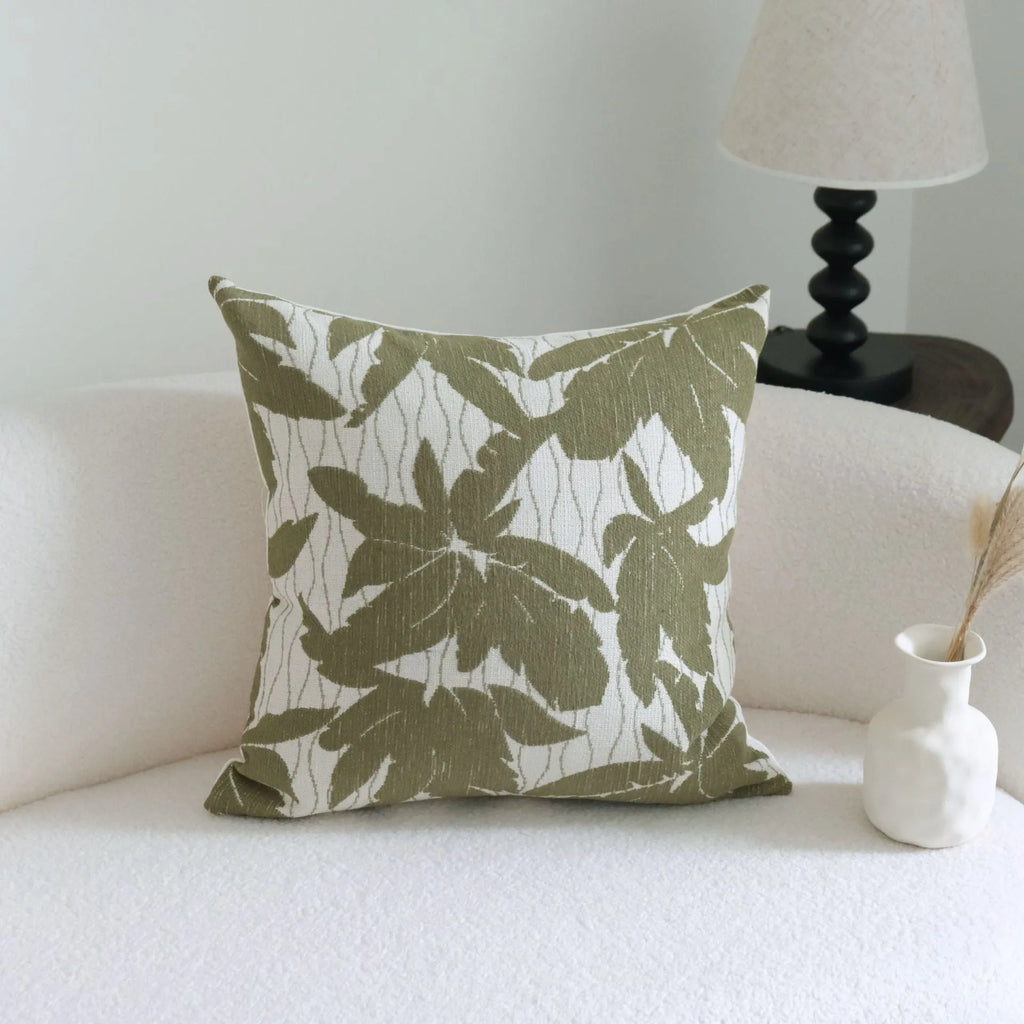 Green striped cotton linen decorative pillow with tassels next to a matching brushed fabric pillow core.